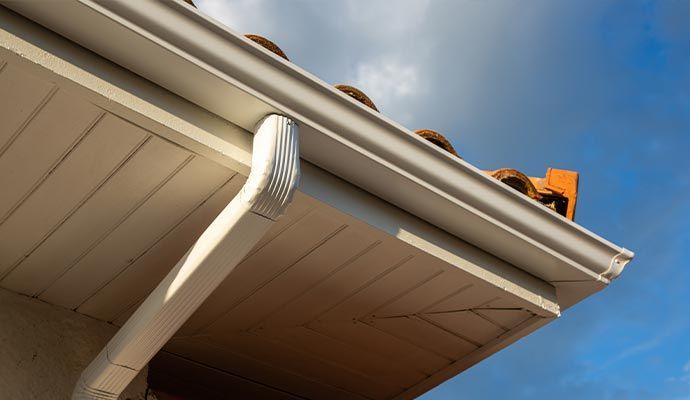 A man is working on the roof of a house.