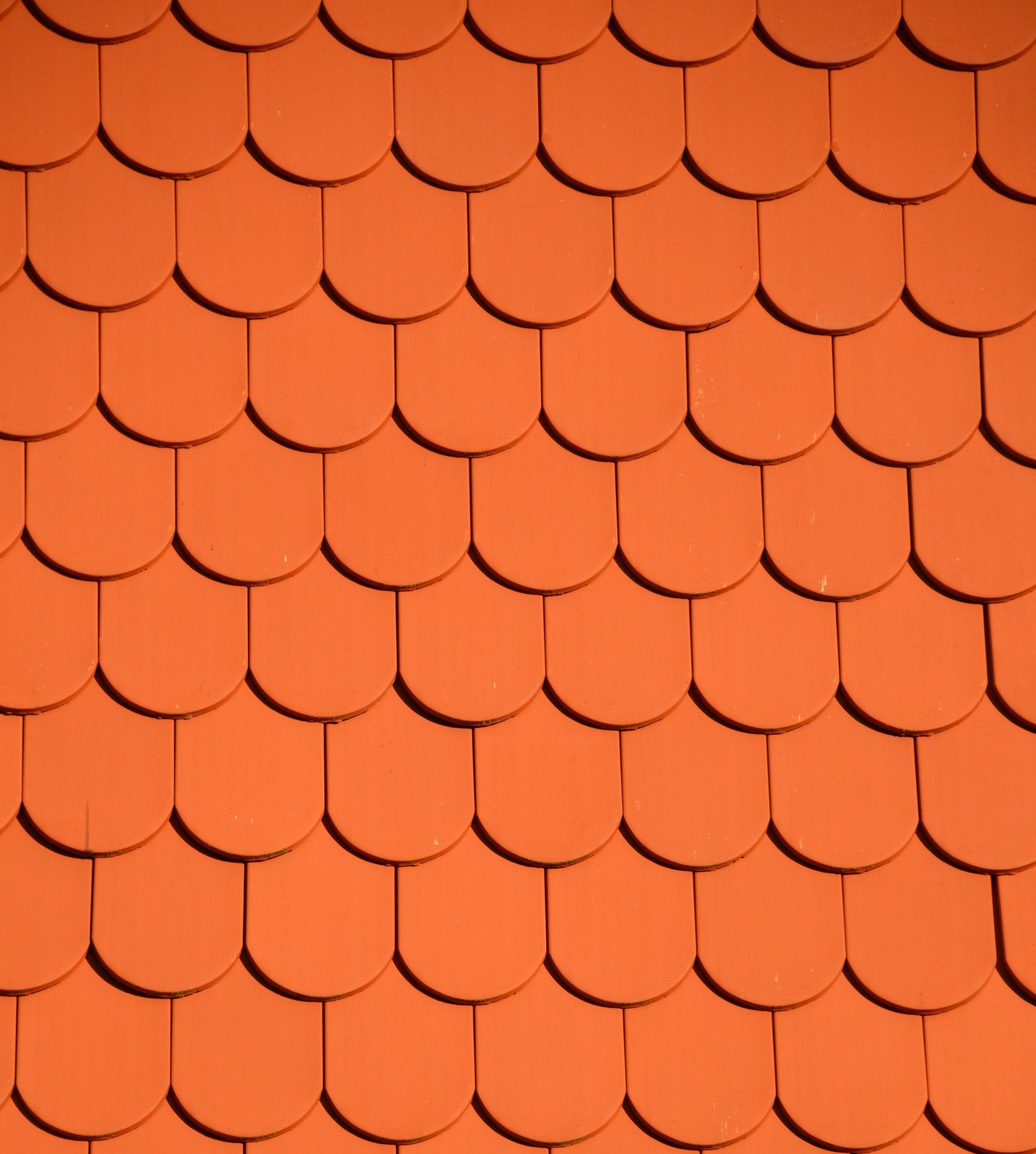 A vibrant red clay ceramic roof adorns the building, adding a touch of warmth and traditional elegance.