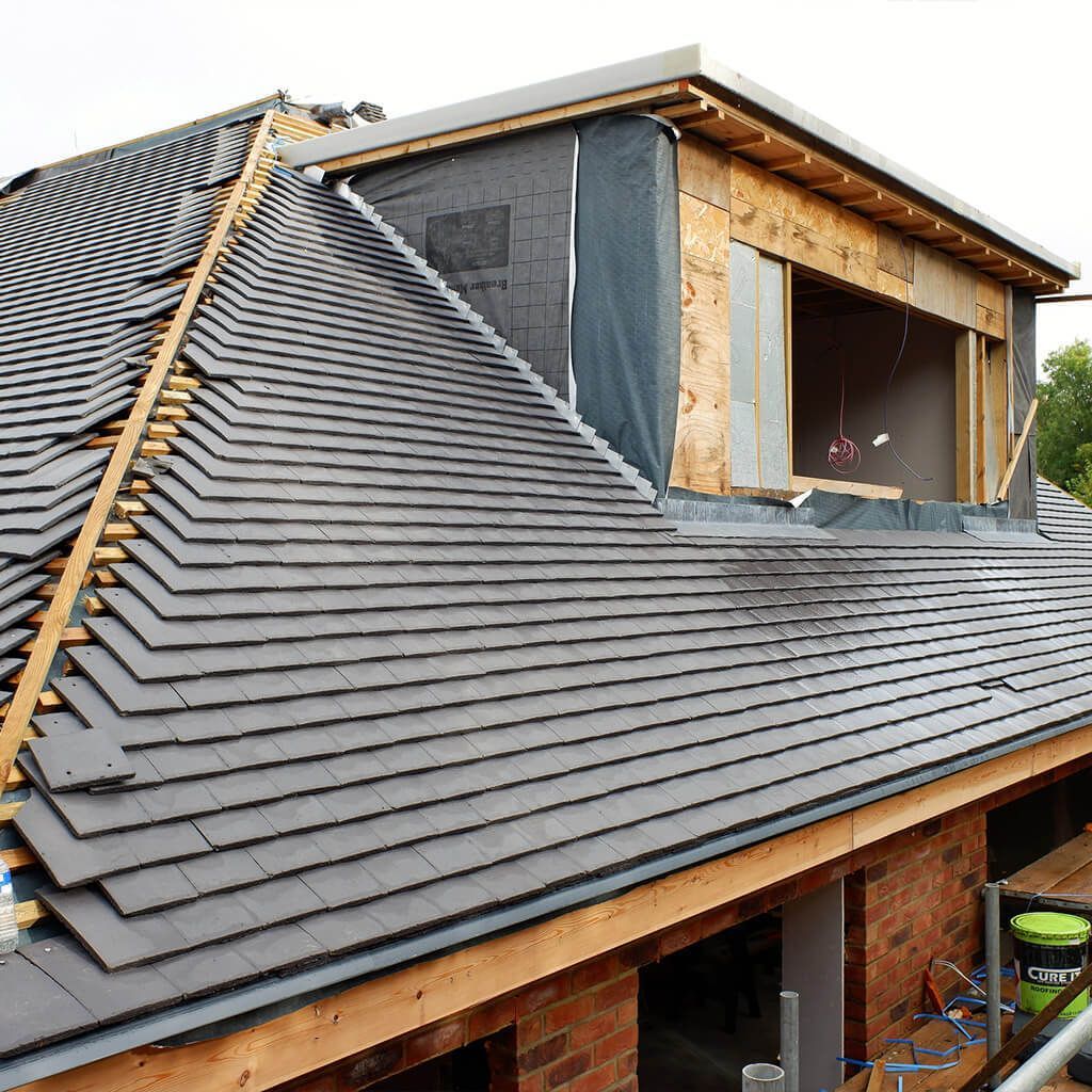 Immaculate slate roof adorning a stunning house, with its deep gray hues adding a touch of elegance and timeless beauty.