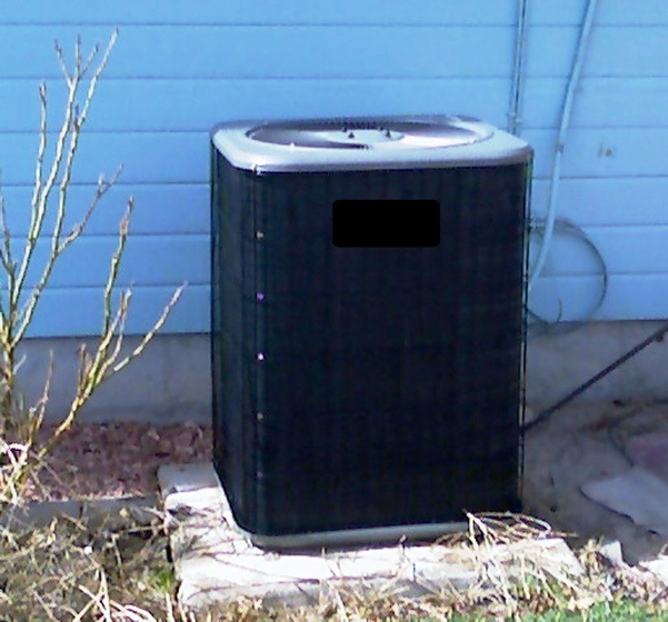 A white truck is parked in a parking lot next to a building.