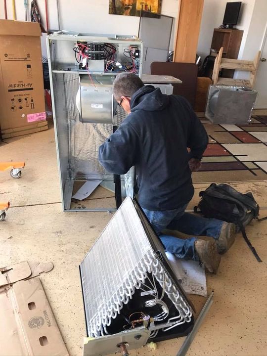 The inside of a moving truck filled with boxes and blankets.