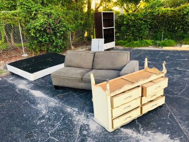 An image of used couches, dressers, mattresses, and cabinets ready for removal.