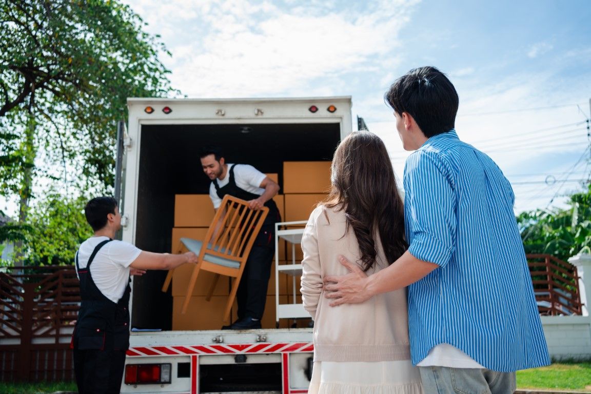An image of persons loading a truck with used furniture.