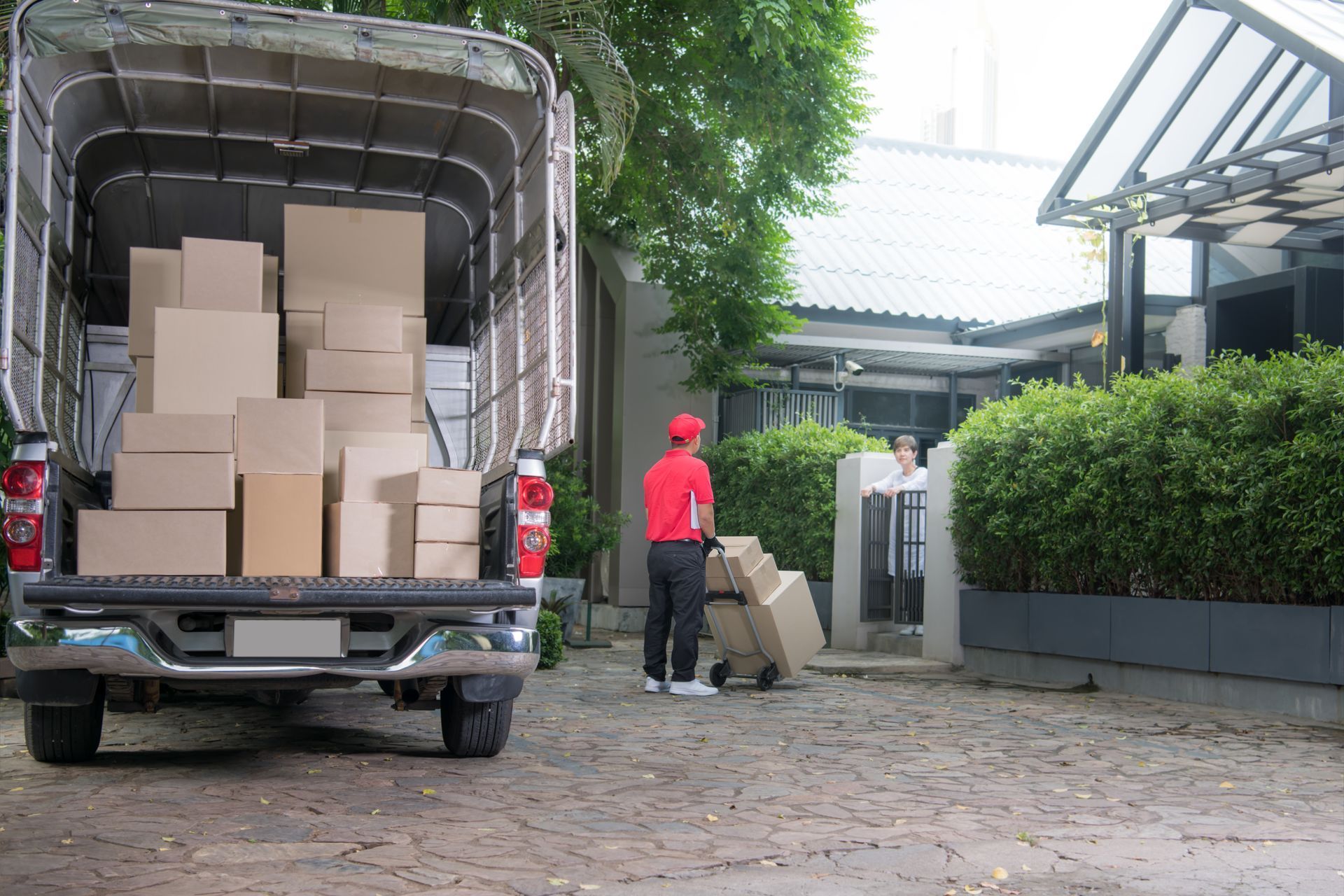 A delivery man is loading boxes into a truck.