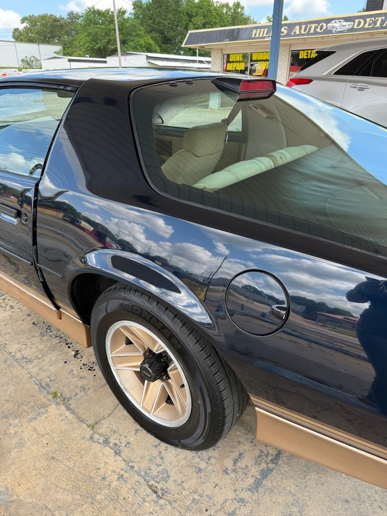A car with a damaged bumper is parked on the side of the road.