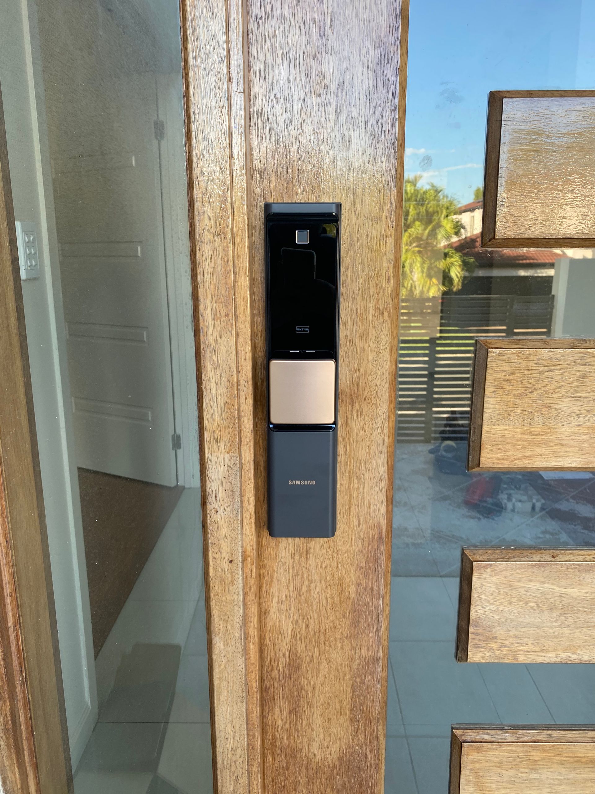 A person is fixing a door with a drill.