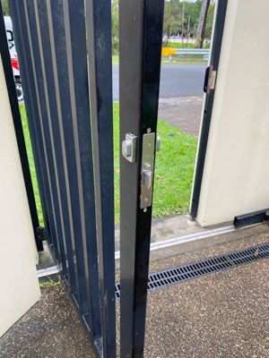 A close up of a sliding gate with a lock on it.