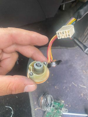 A person is holding a piece of electrical equipment in their hand.