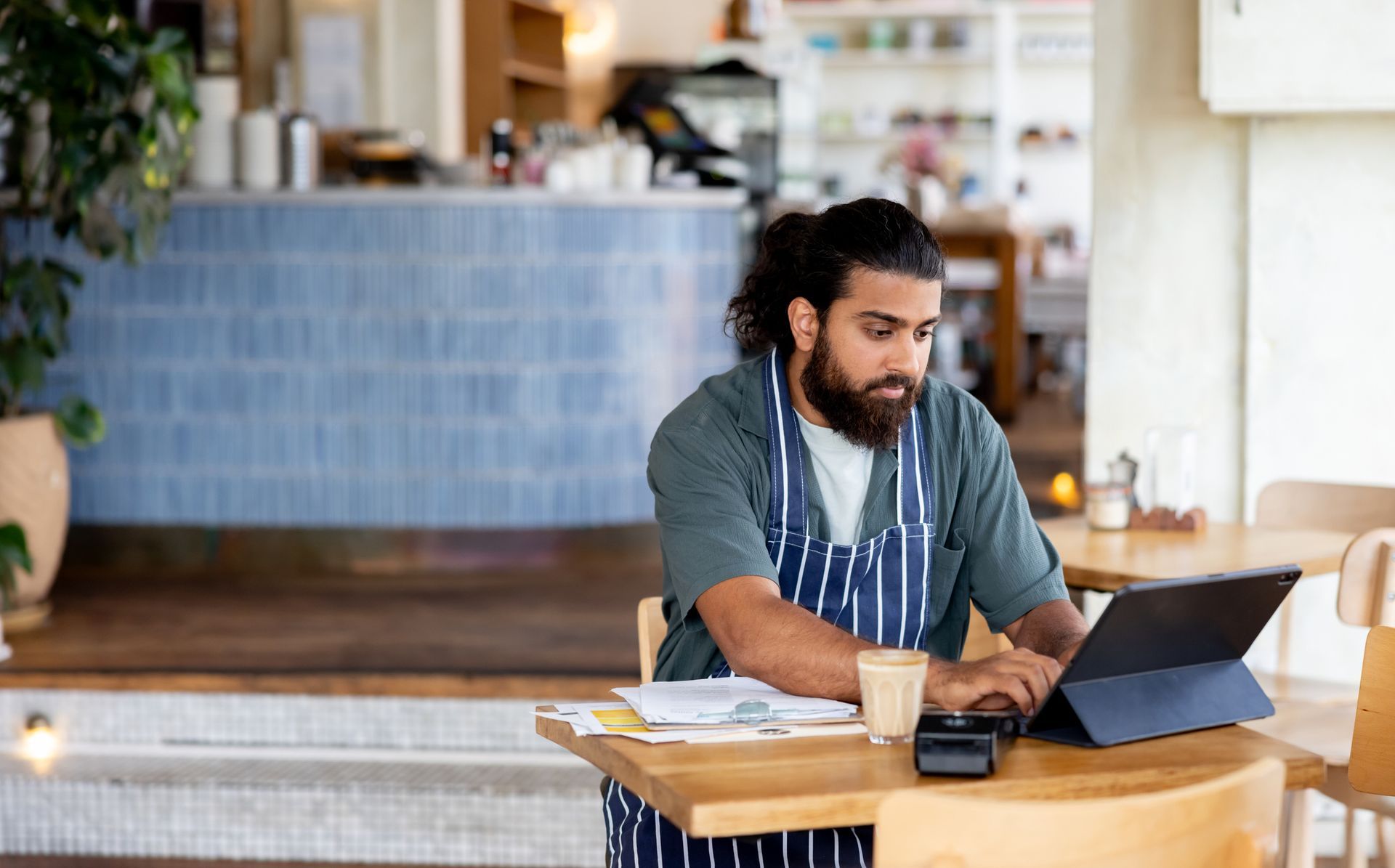 Woman pointing at document, consulting with man in a modern office.