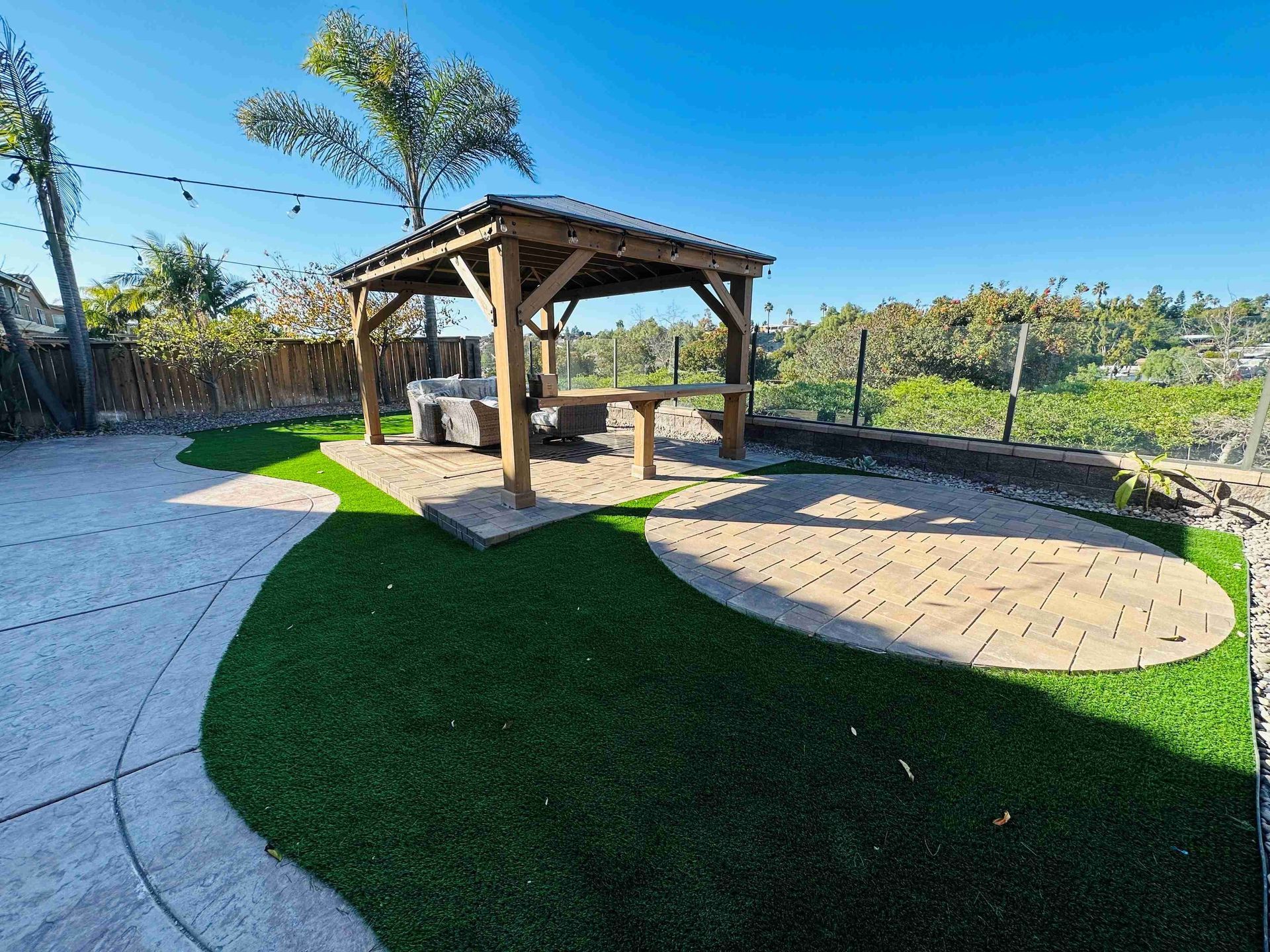 There is a gazebo in the middle of the backyard.