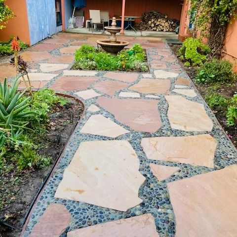 A stone walkway with a fountain in the middle of it