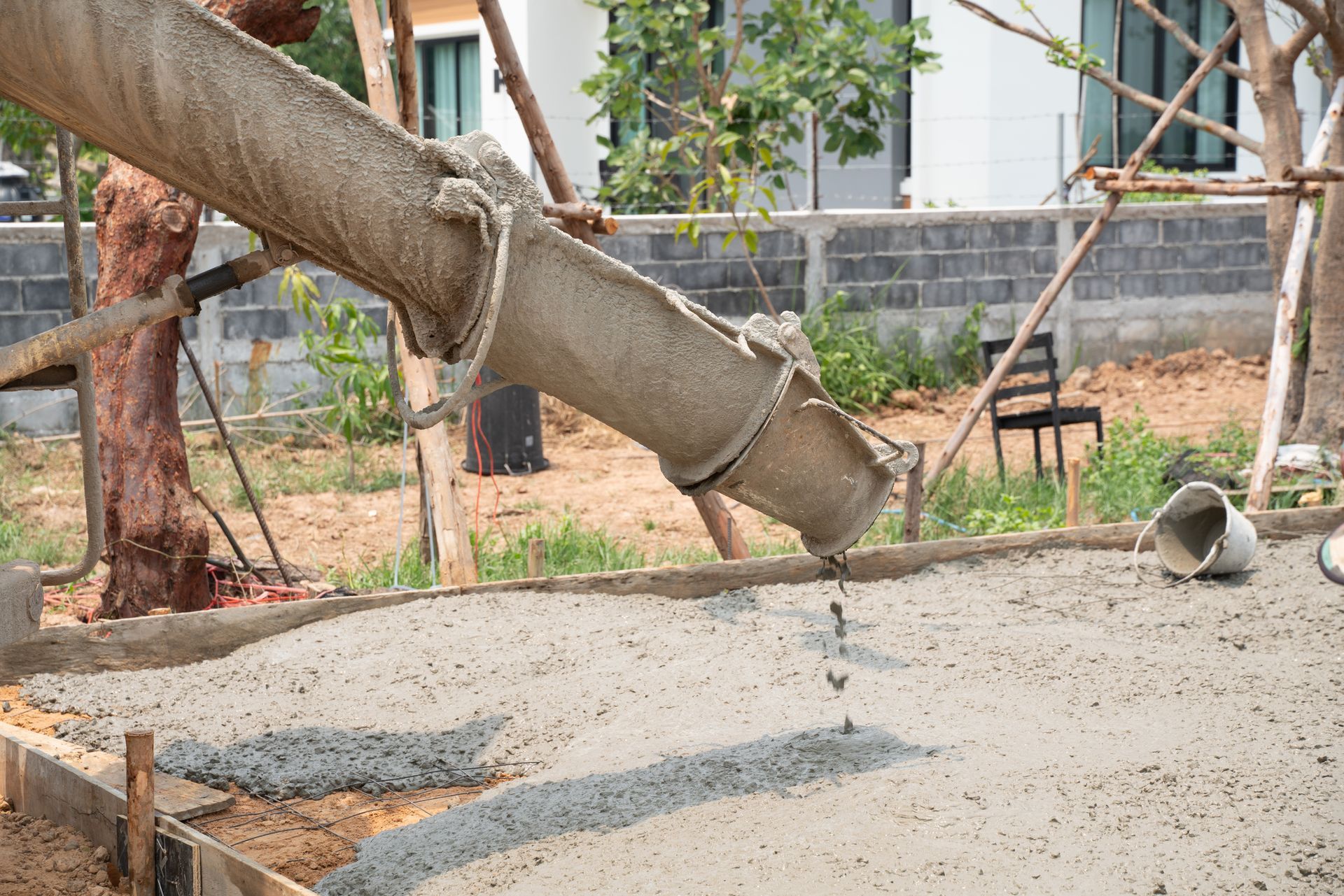 A concrete pump is pouring concrete on a construction site.