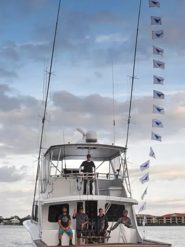 A group of people are sitting on a boat in the water.