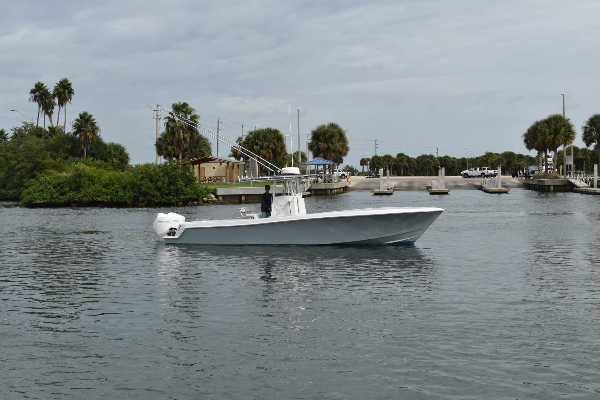 A white boat is floating on top of a body of water.