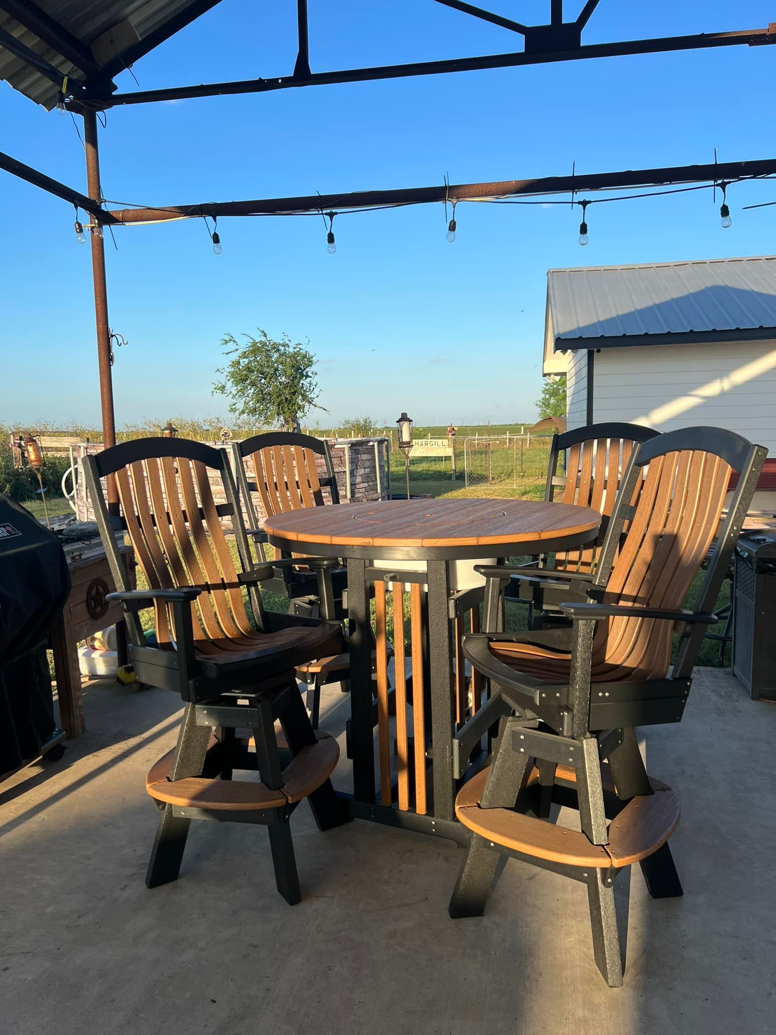 A table and chairs are sitting under a canopy on a patio.