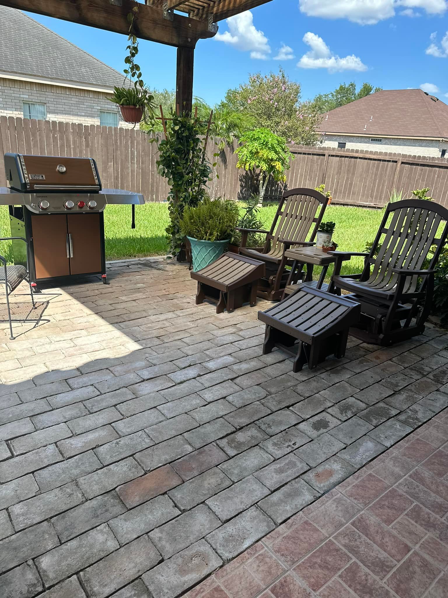 There is a grill and chairs on the patio.