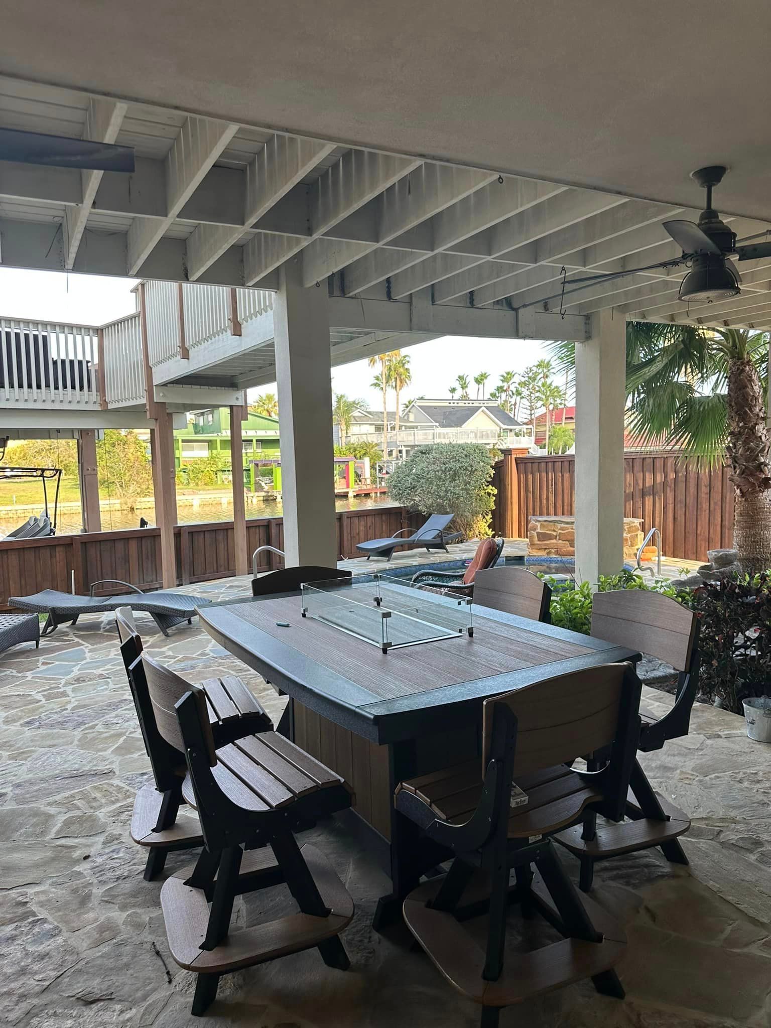 A patio with a table and chairs under a pergola.