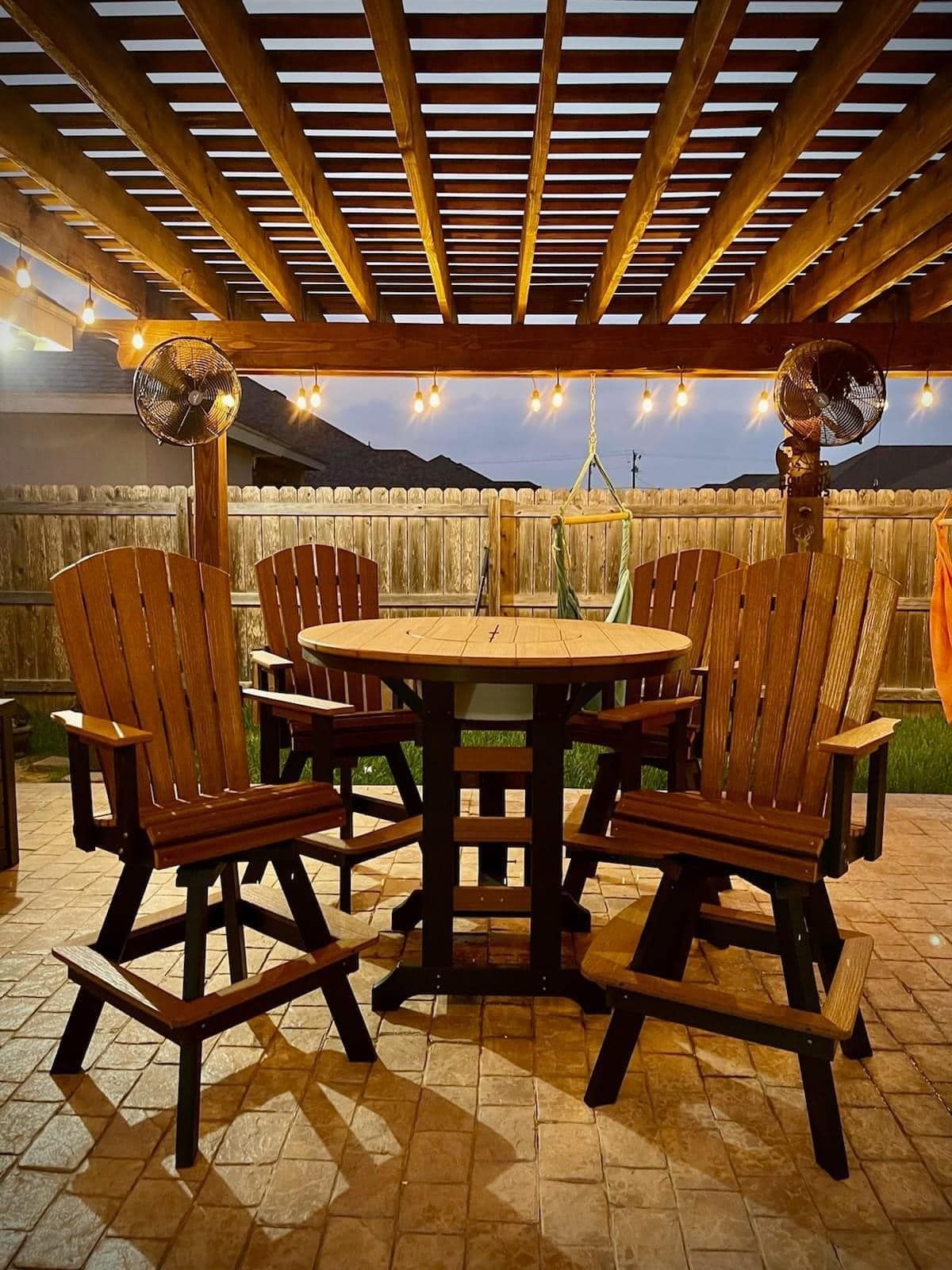 A patio with a table and chairs under a pergola.