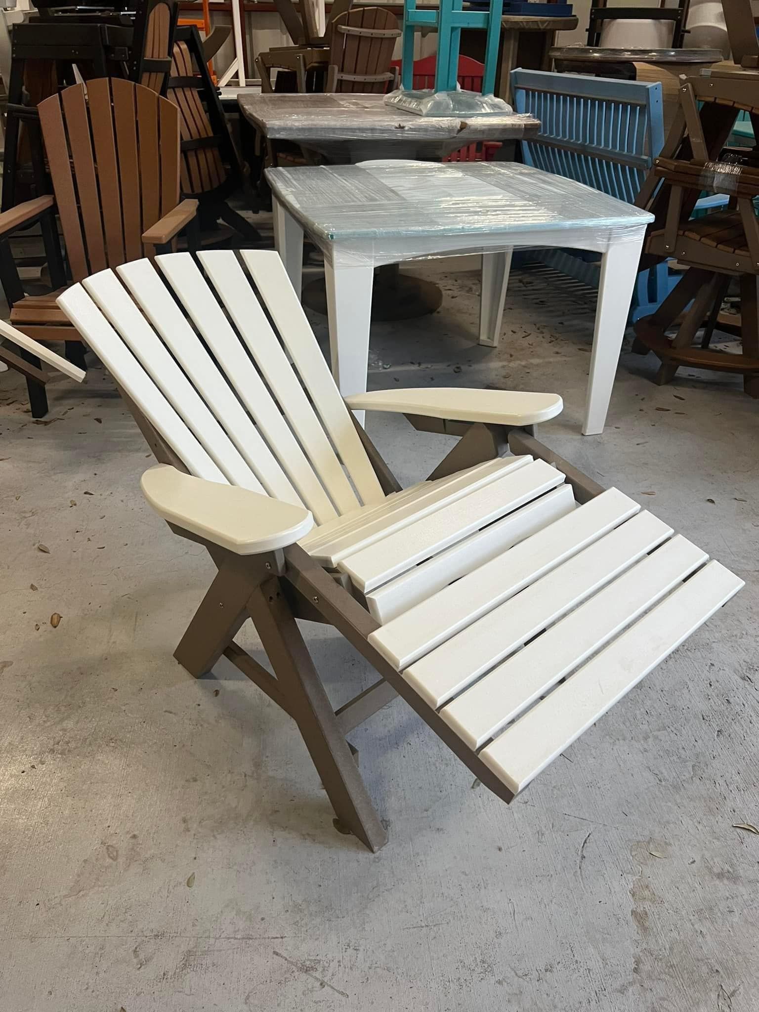 A wooden chair with a foot rest is sitting in a room with other chairs and tables.
