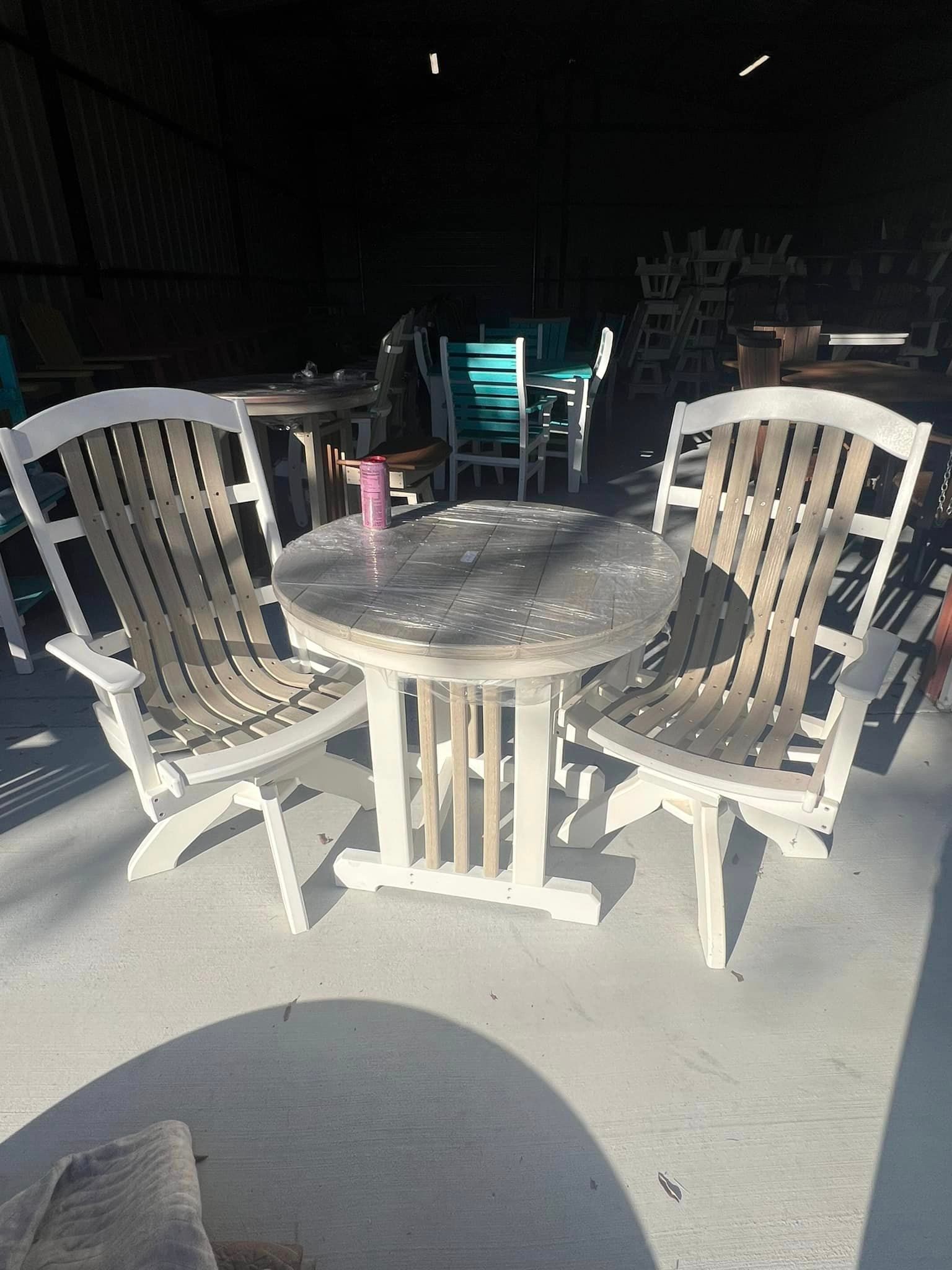 A table and chairs are sitting on a concrete floor.