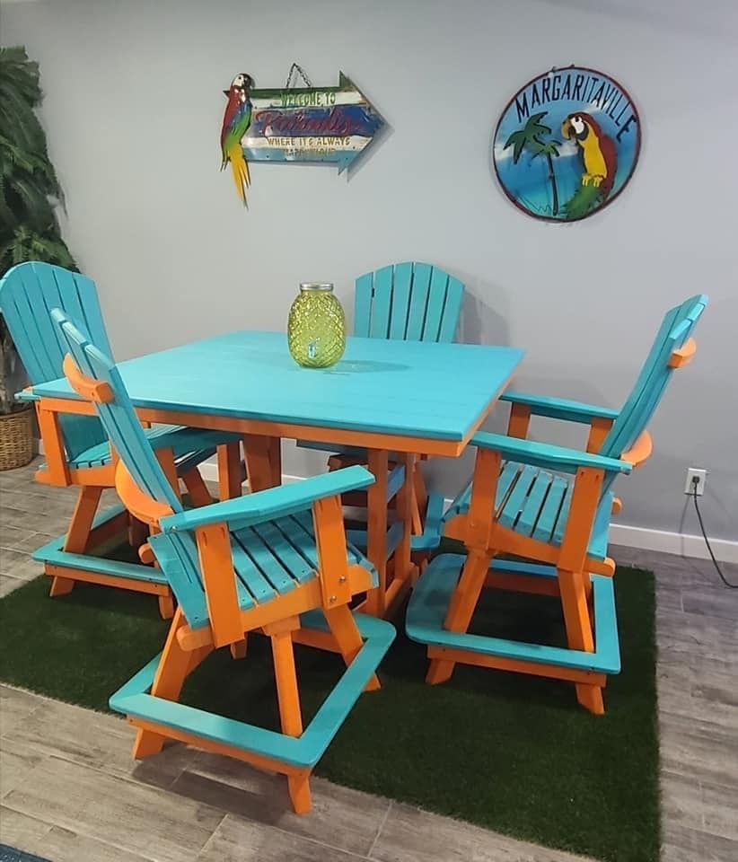 A dining room with a blue table and orange chairs