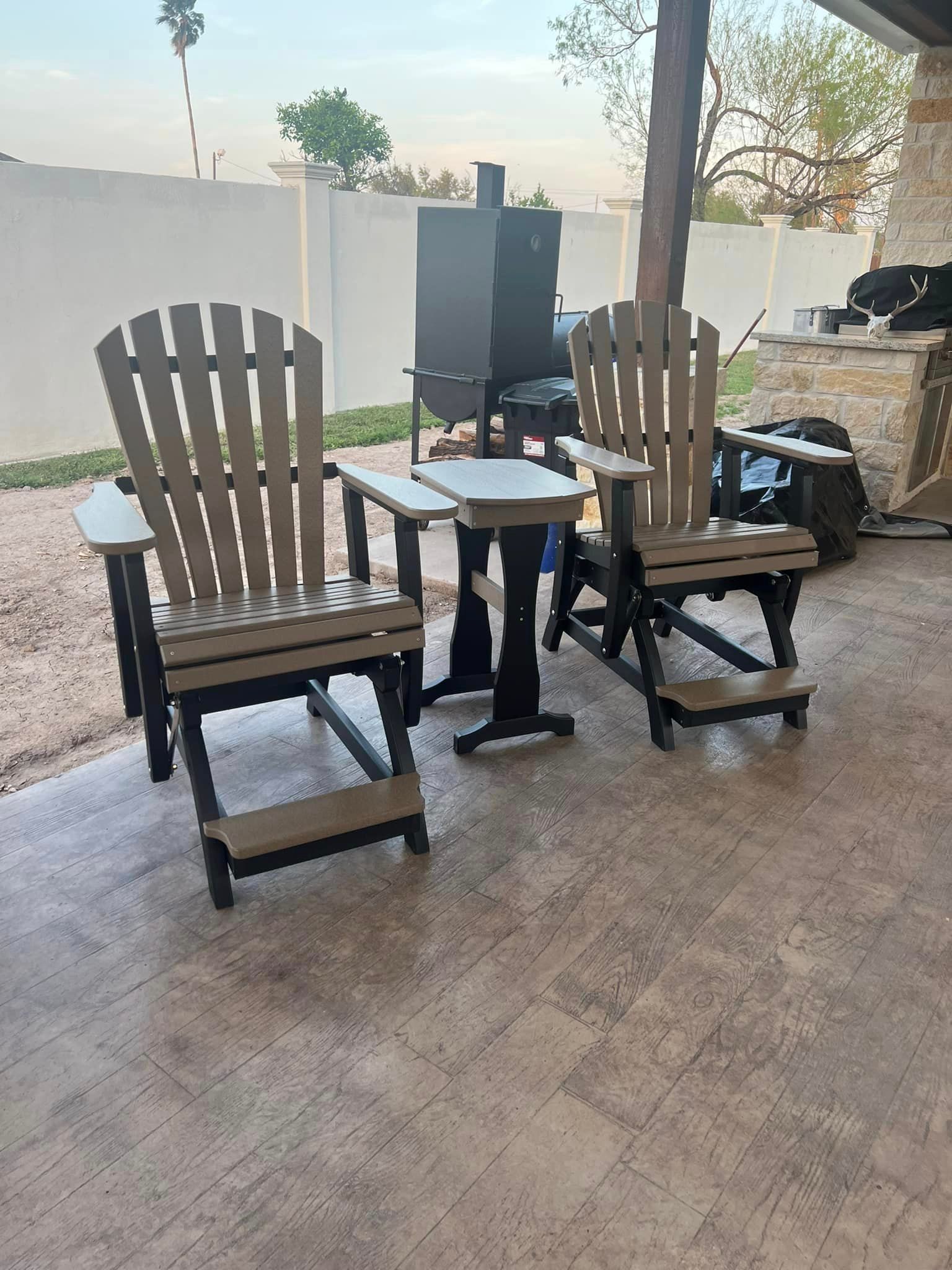 A group of chairs and a table on a patio.