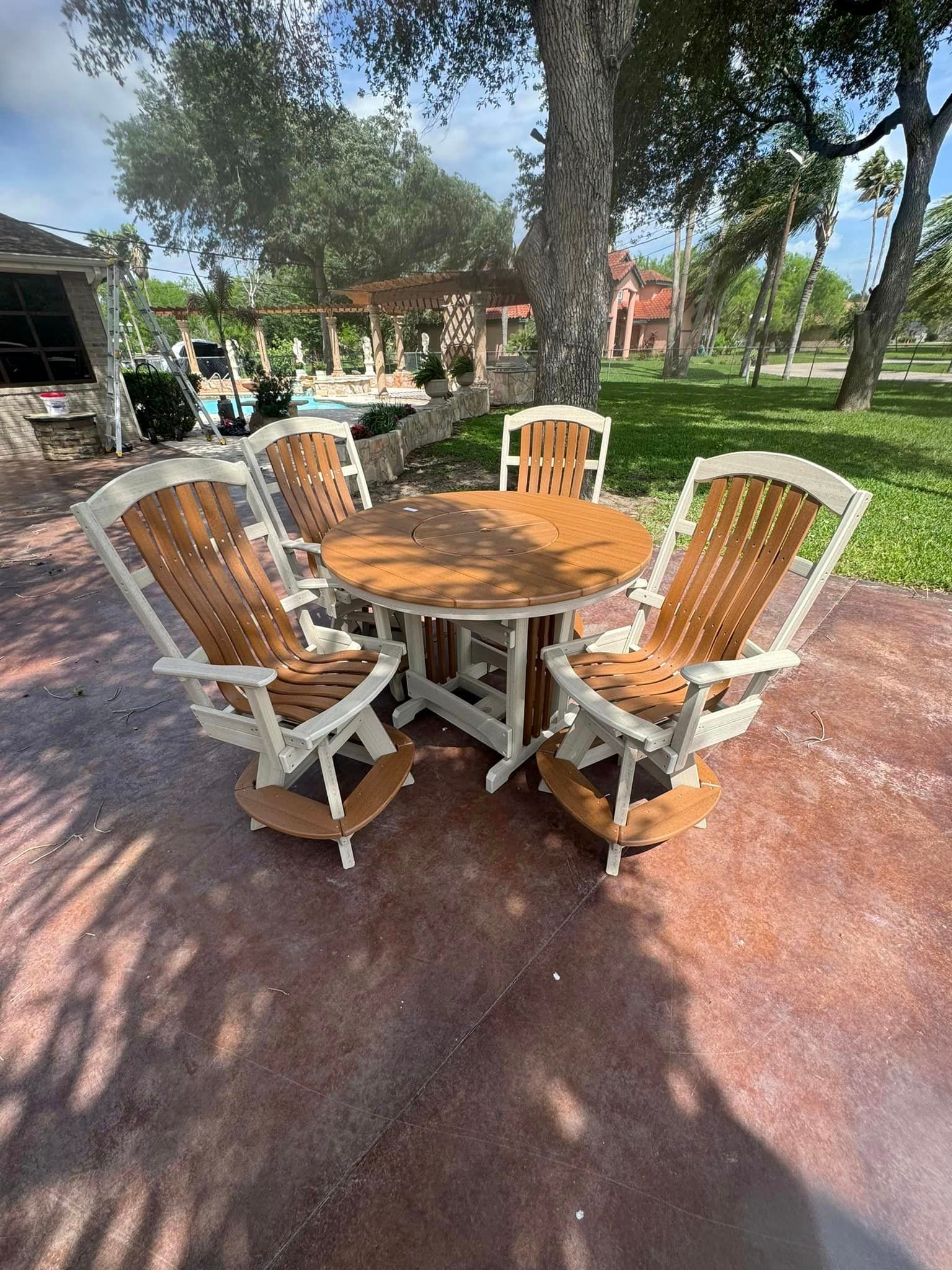 A table and chairs are sitting on a patio in a park.