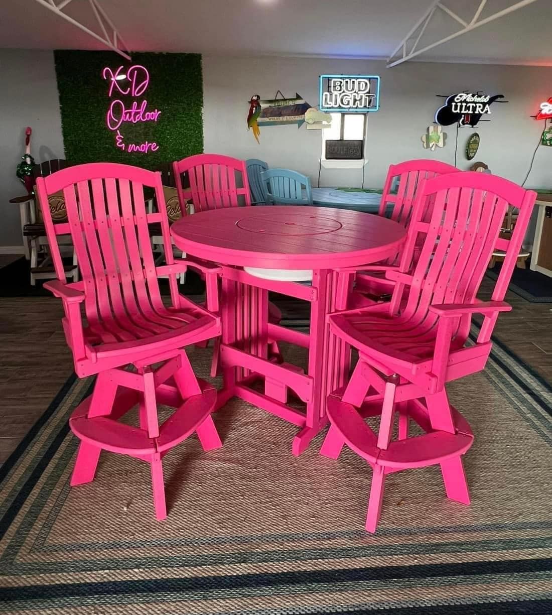 A room with pink chairs and a pink table