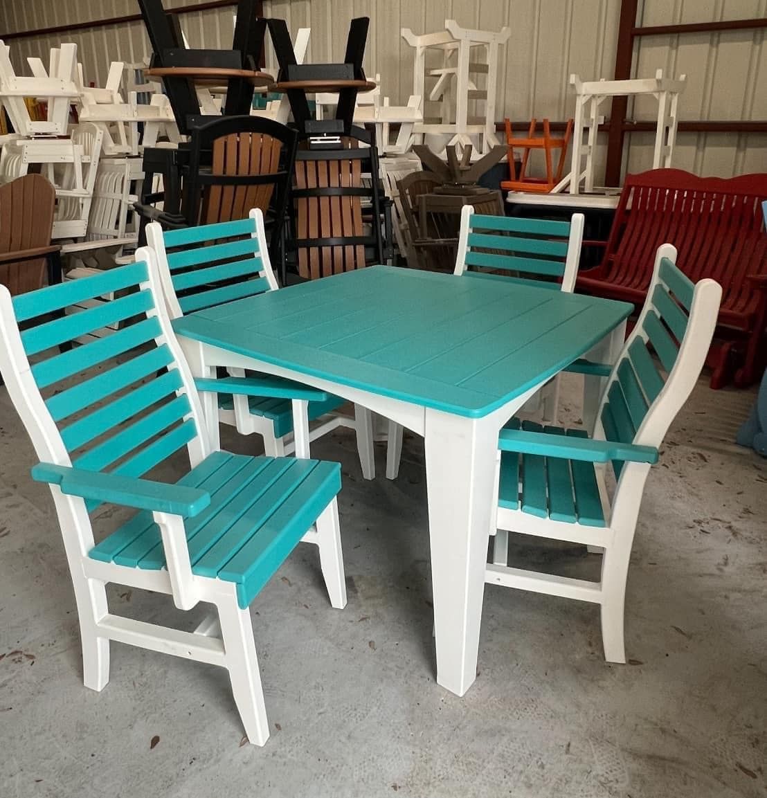 A table and chairs are sitting in a warehouse