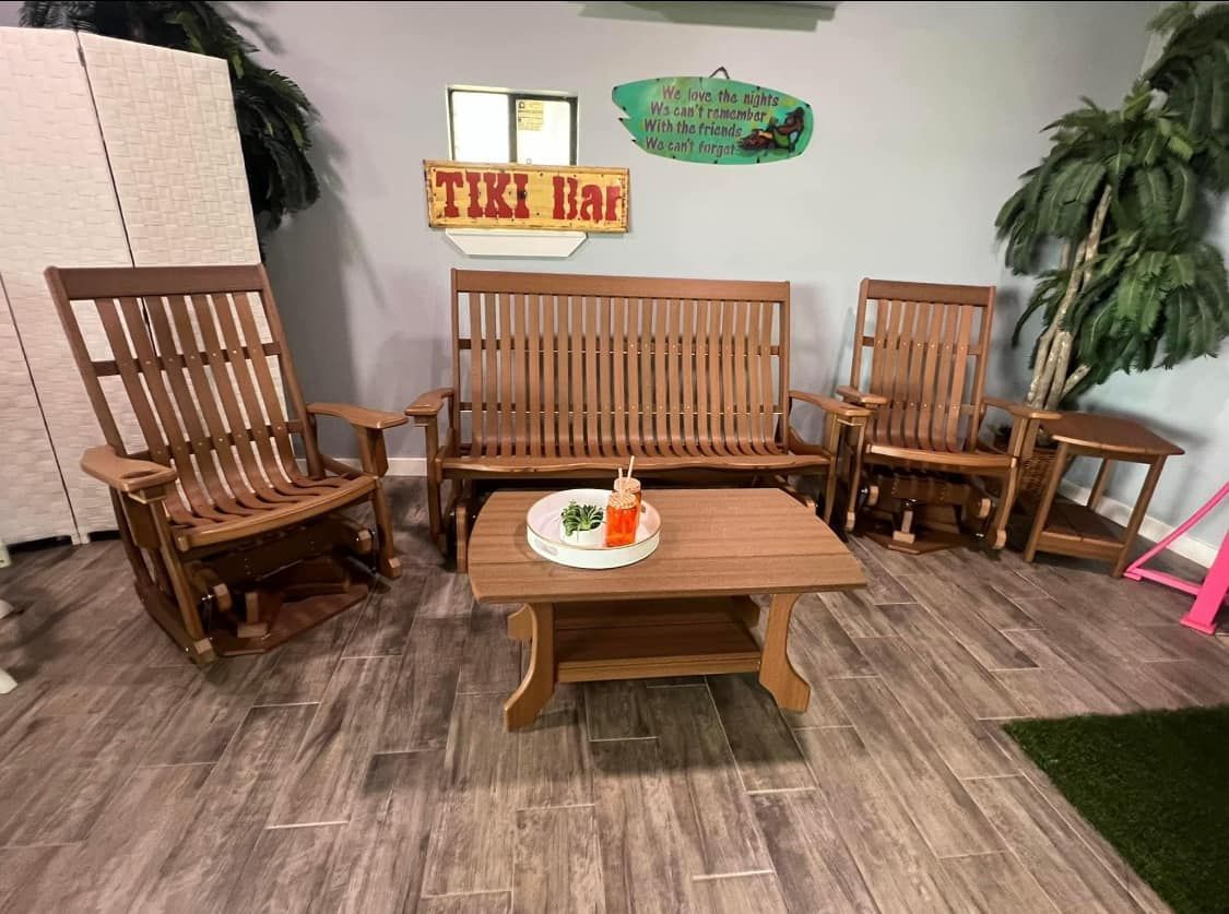 A living room with wooden furniture and a tiki bar sign on the wall.