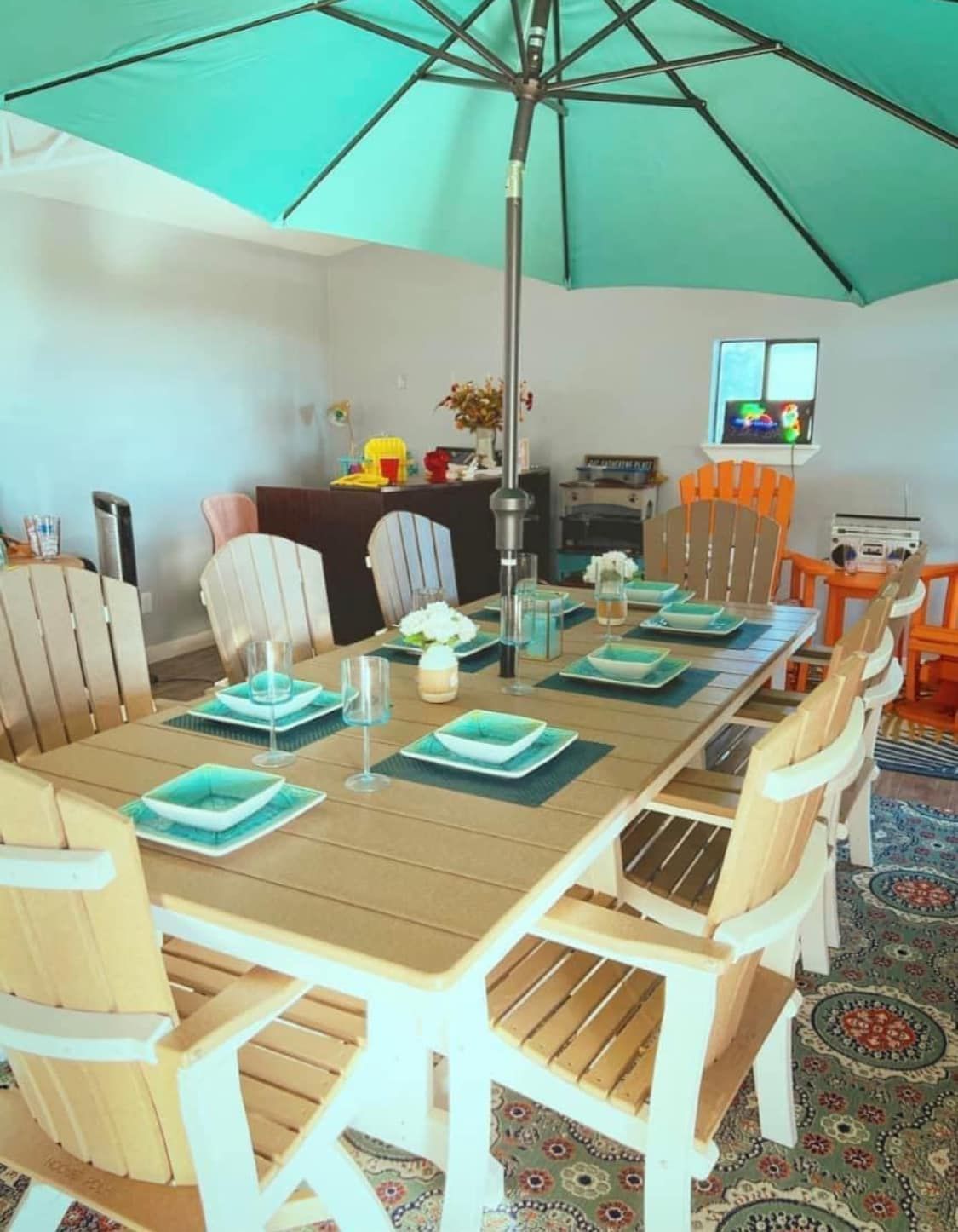 A patio with a table and chairs under an umbrella