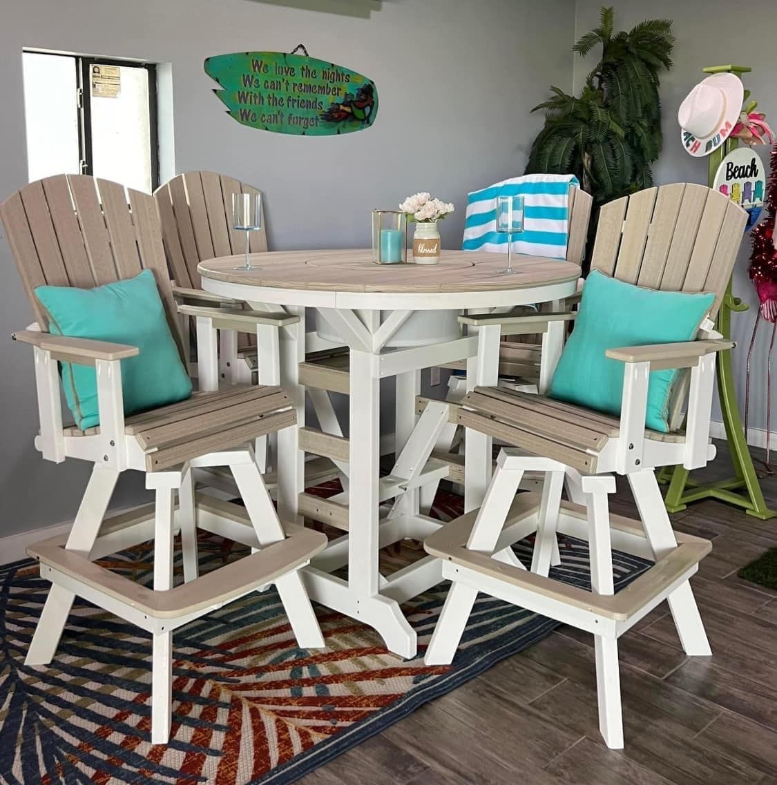 A dining room with a table and chairs and a rug.