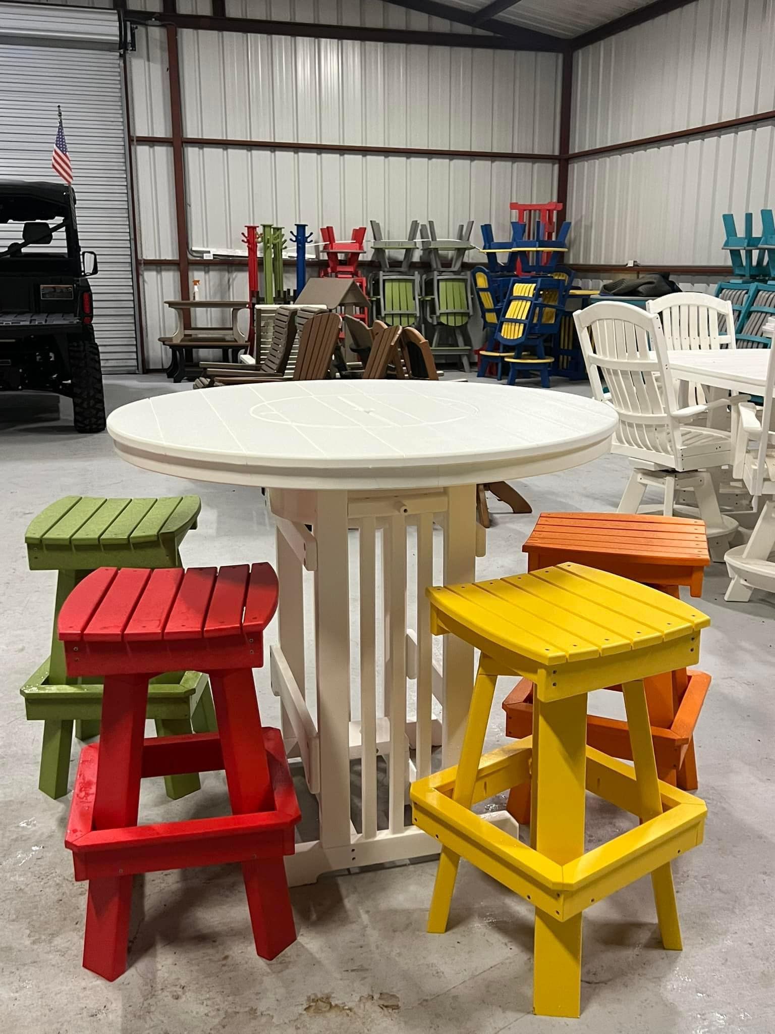 A table and stools are sitting in a warehouse.