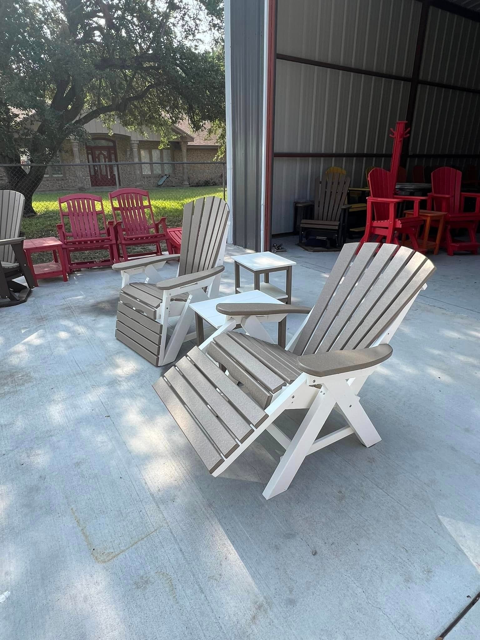 A group of chairs are sitting on a concrete patio in front of a building.