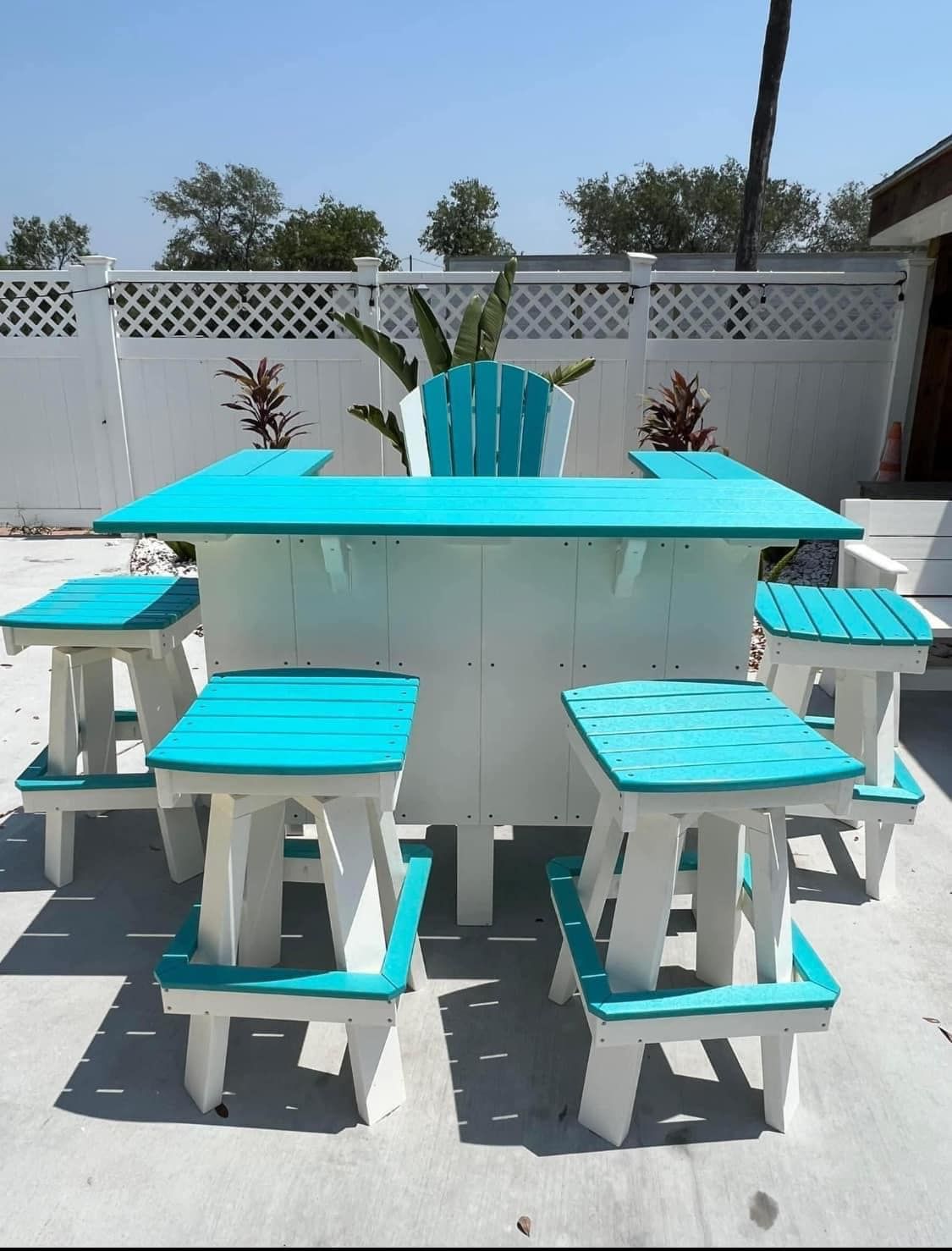 A white table with blue seats and a blue chair