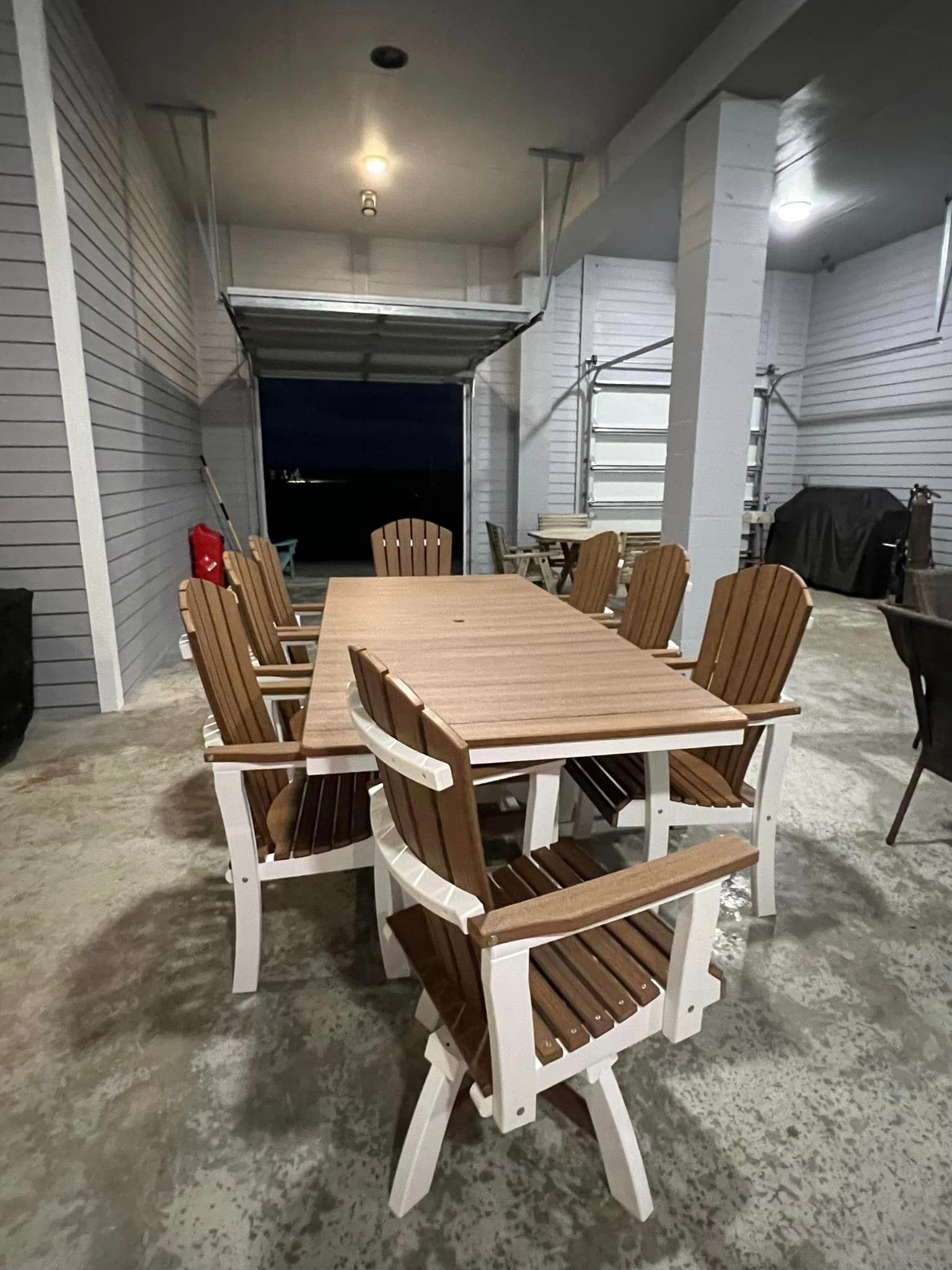 A wooden table and chairs are sitting in a garage.
