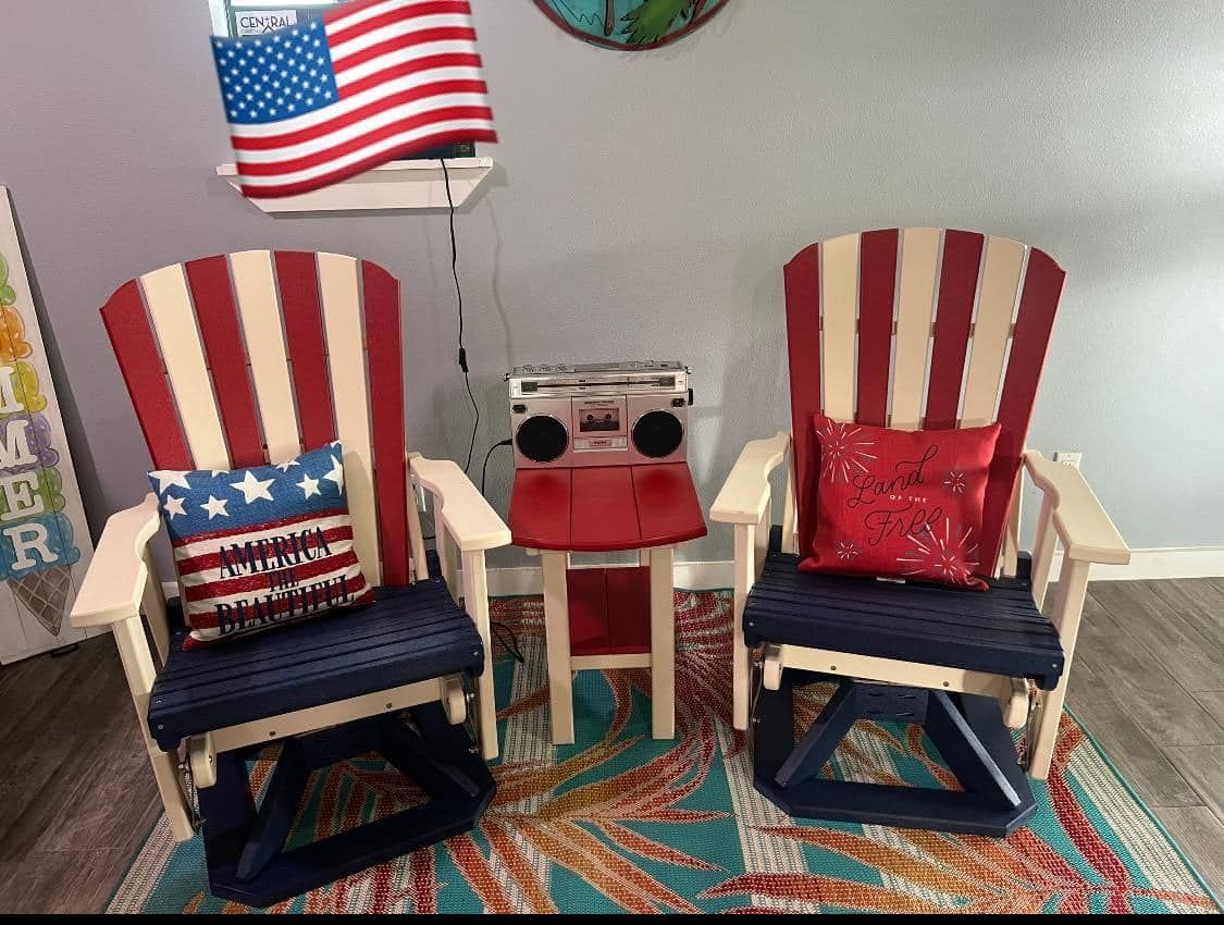 Two red white and blue rocking chairs are sitting next to each other in a room.