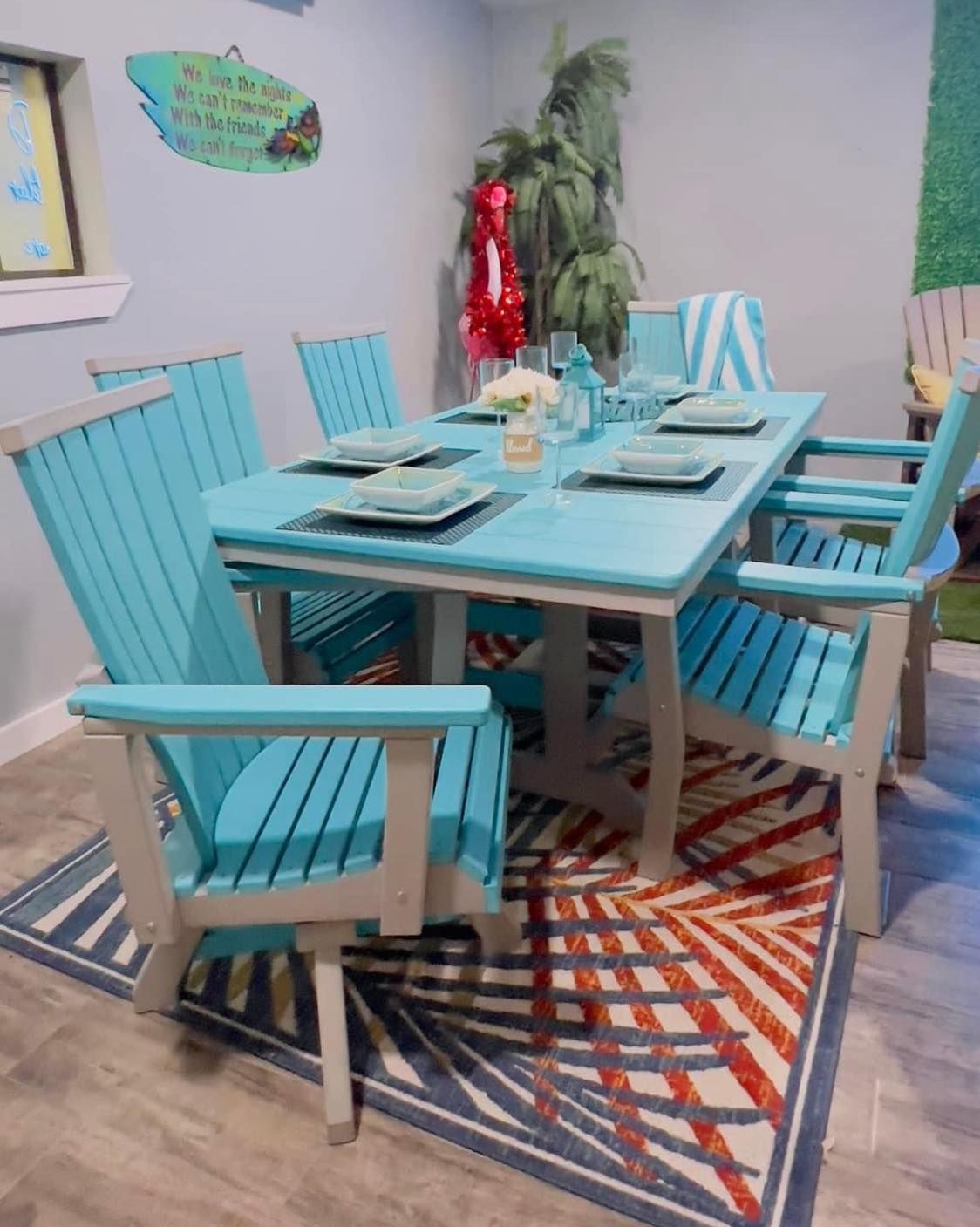 A dining room with a table and chairs and a rug.