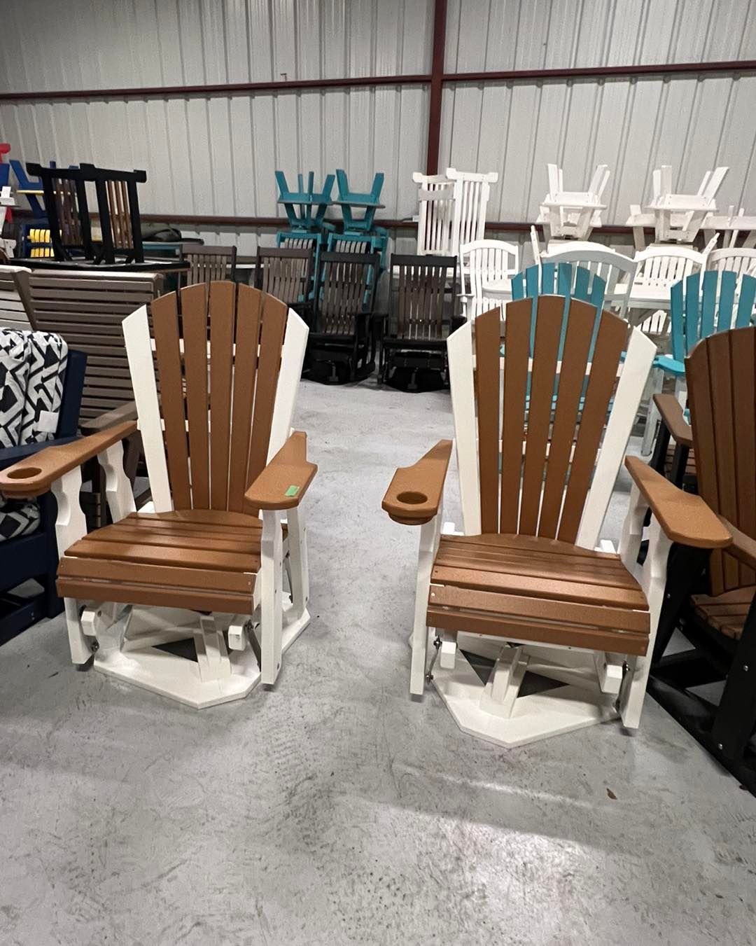 Two wooden chairs are sitting next to each other in a warehouse.