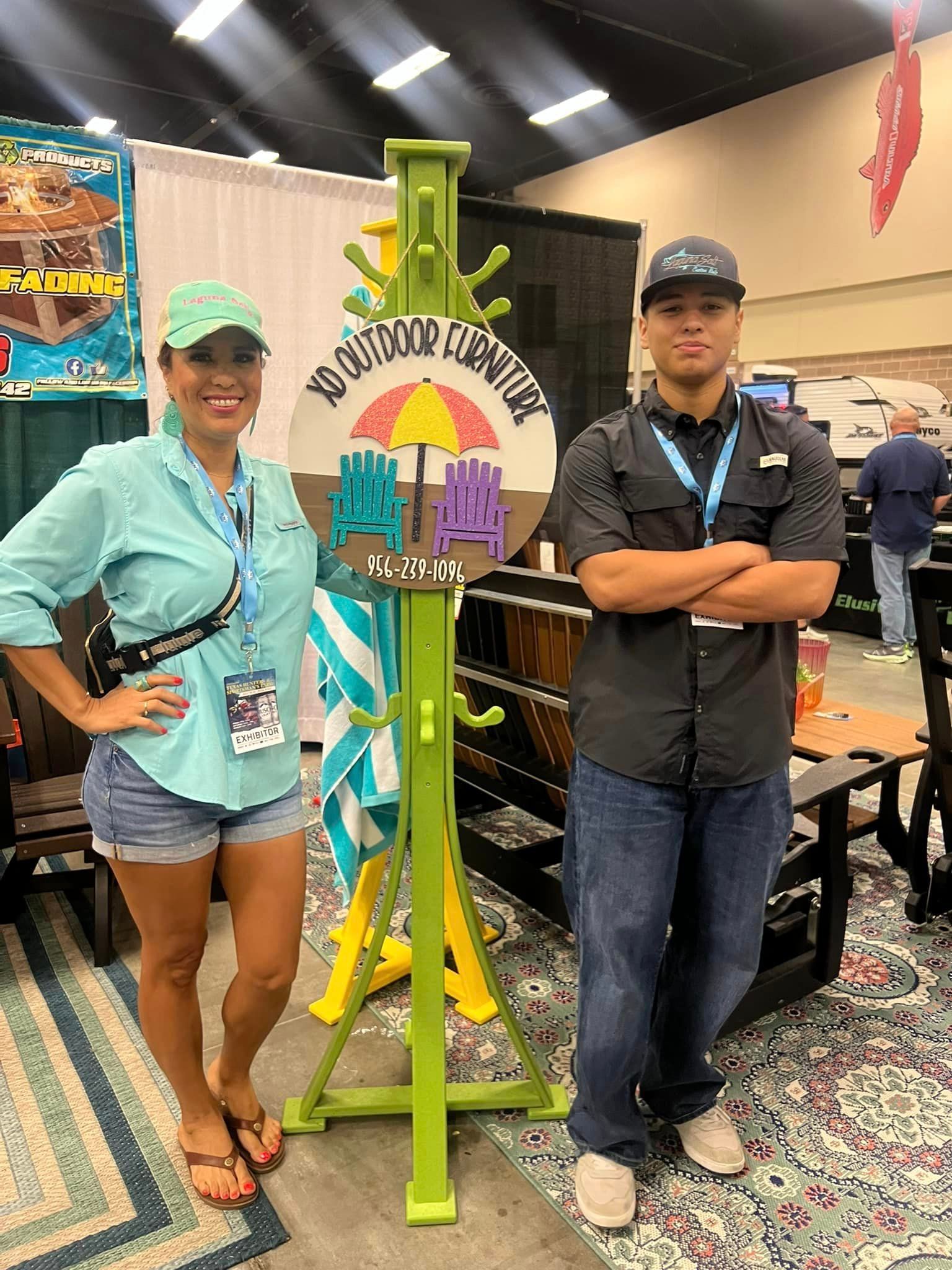 A man and a woman are standing next to each other in front of a sign.