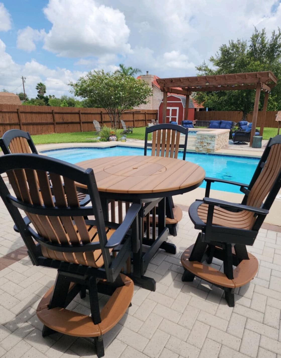 A table and chairs in front of a swimming pool