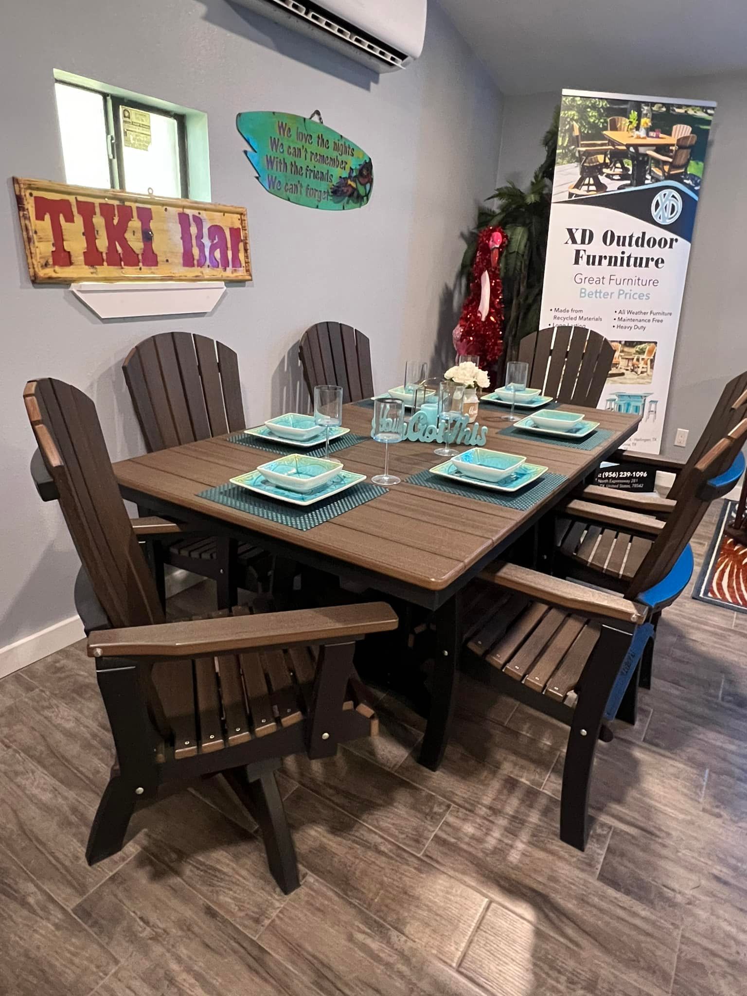 A dining room table and chairs with plates and glasses on it.