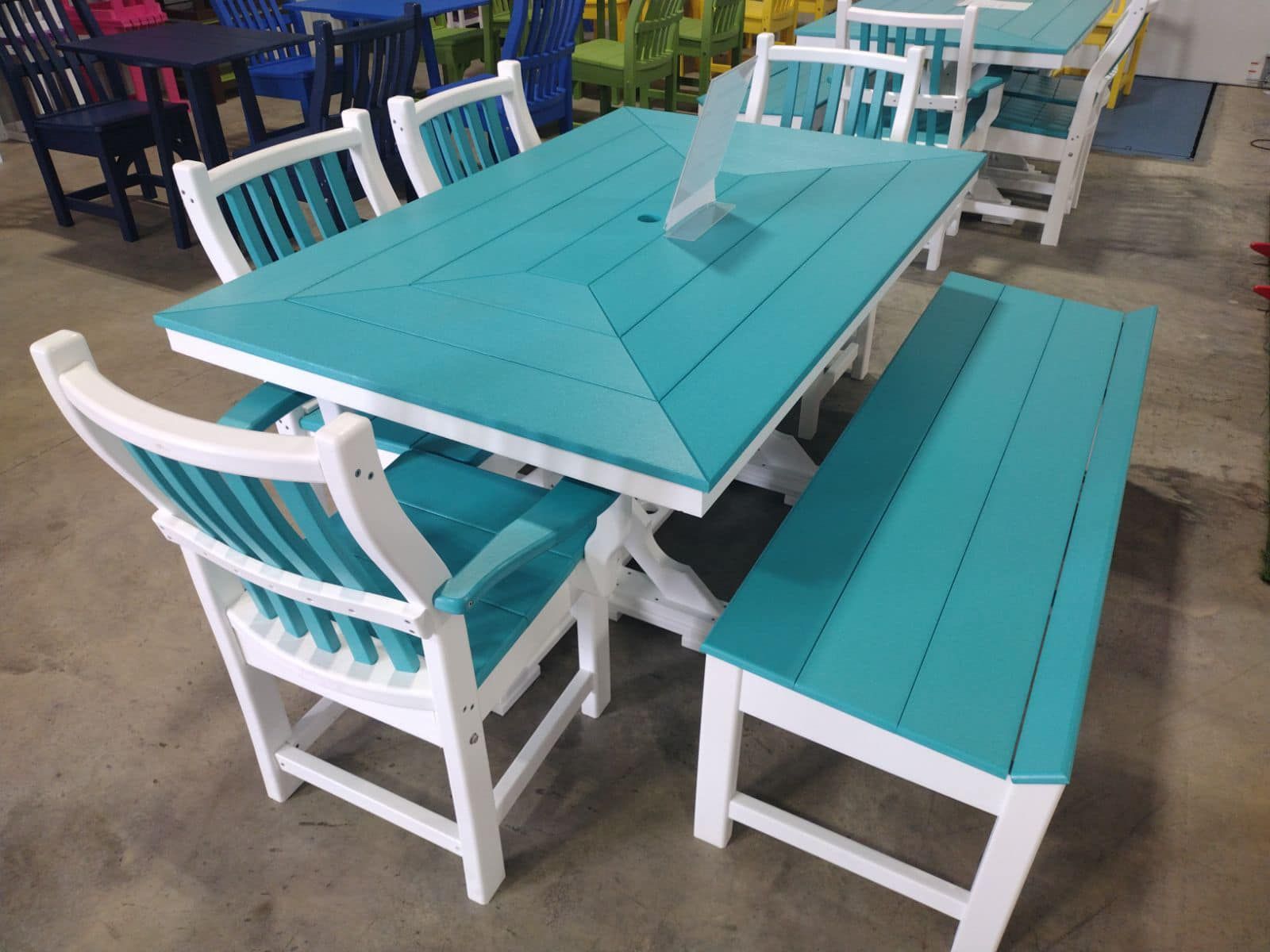 A blue table with white chairs and a bench