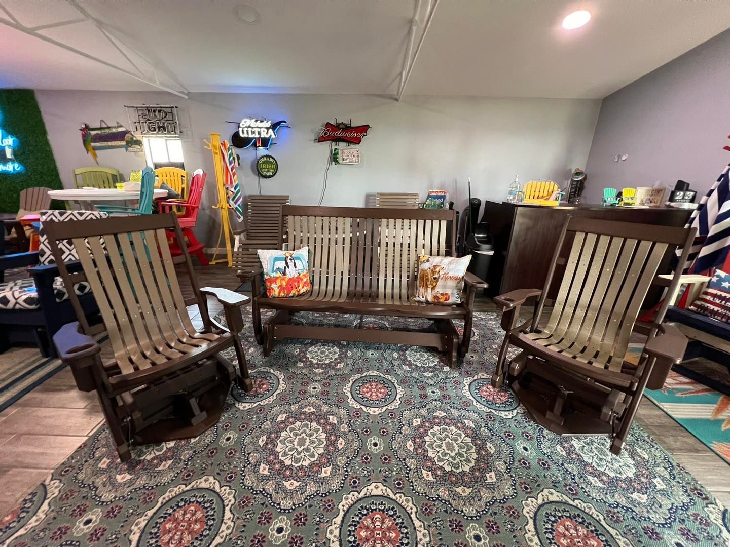 A living room with a bench and two rocking chairs.