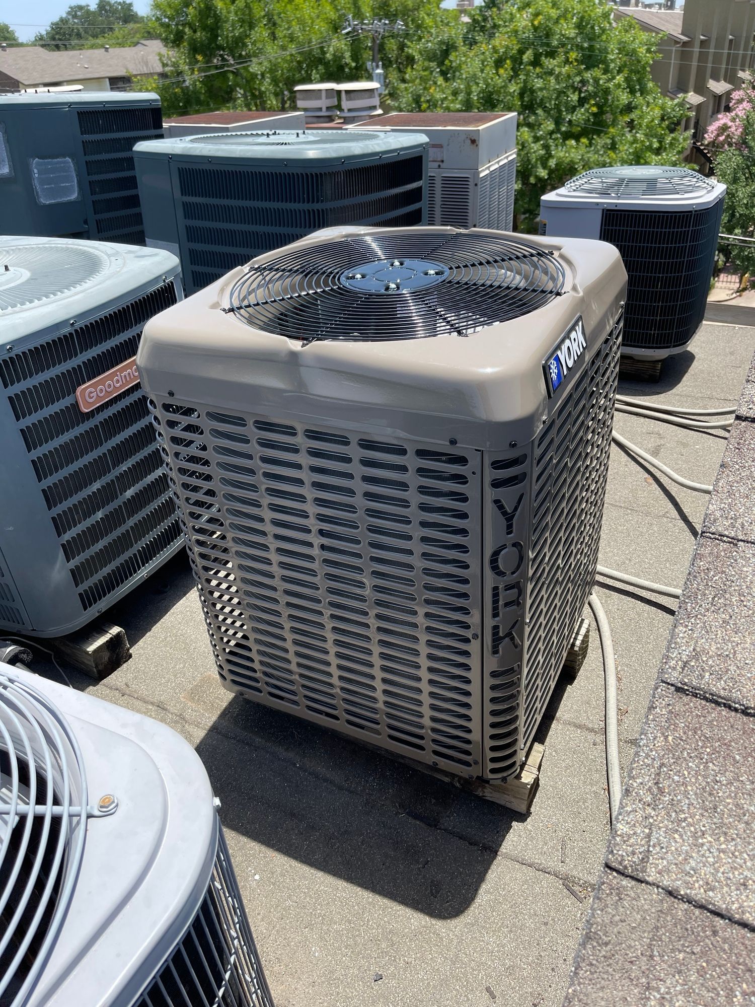 a group of air conditioners are sitting on top of a roof .
