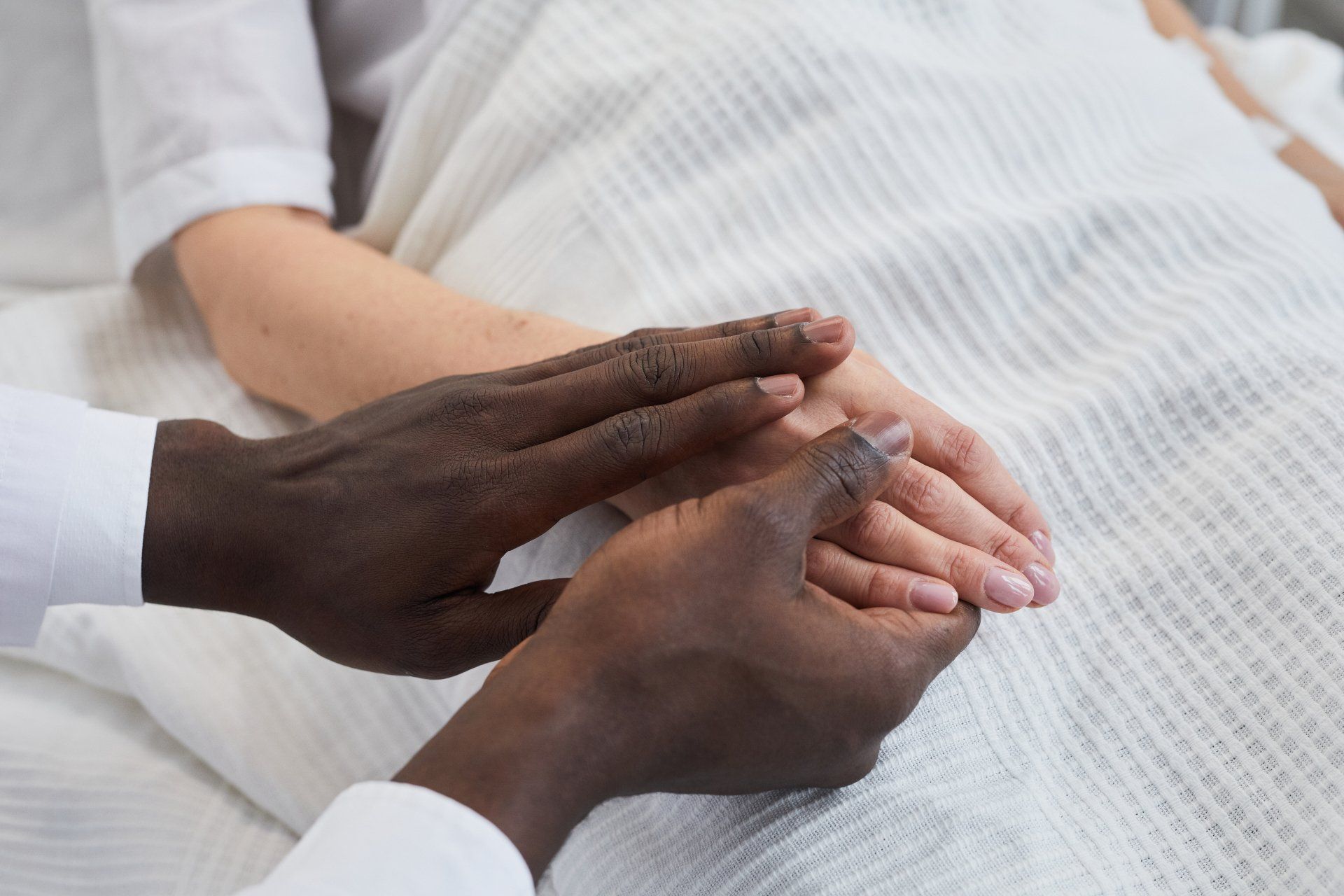 Family Holding An Elderly Persons Hand
