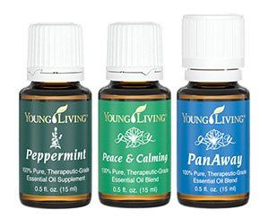 three bottles of young living essential oils on a white background .