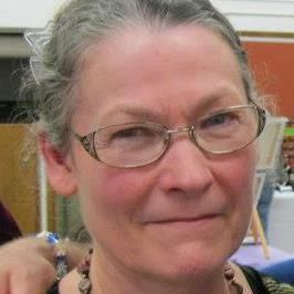 a close up of a woman wearing glasses and a necklace .