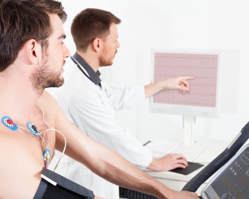 a man is being monitored by a doctor on a treadmill