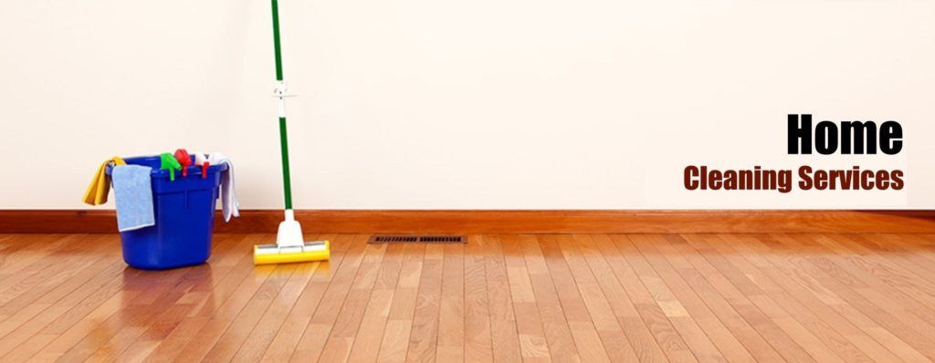 A blue bucket with cleaning supplies and a mop on a wood floor, with the text 